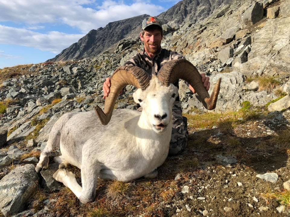 Happy hunter John D. from Texas with his trophy lynx and guide Jeff Baher.